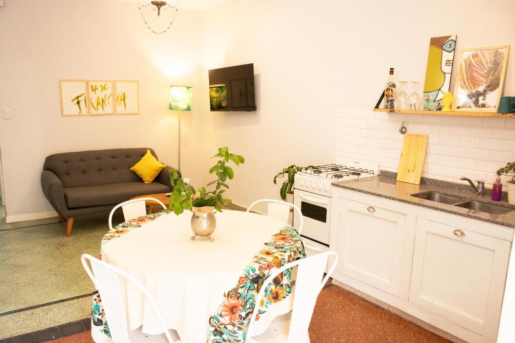 a kitchen with a table and chairs and a couch at Casona Antigua con Jacuzzi a metros de la Basílica de Luján in Luján