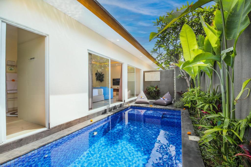 a swimming pool in the middle of a villa at Le Cielo Romantic Villas by Maviba in Seminyak