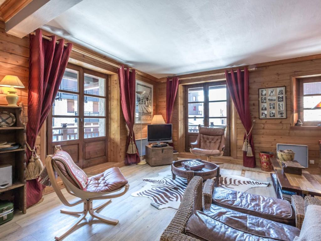 a living room with a couch and chairs and windows at Appartement de charme avec balcon, 8 pers, décor raffiné, au cœur de Val-d’Isère, proche des pistes - FR-1-694-106 in Val dʼIsère