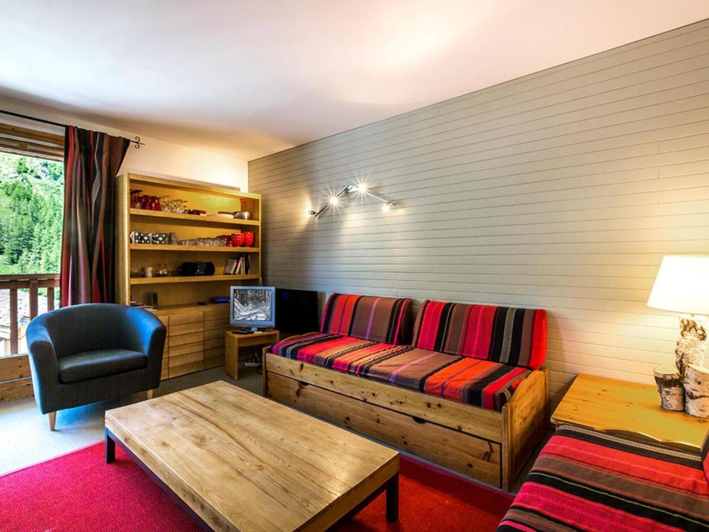 a living room with a couch and a table at Appartement Val-d'Isère, 5 pièces, 8 personnes - FR-1-694-151 in Val-d'Isère