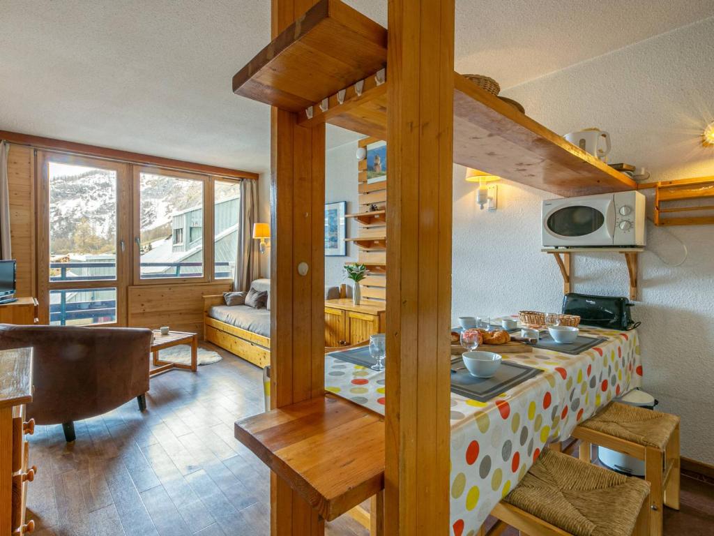 a room with a living room with a table and a couch at Studio Val-d'Isère, 1 pièce, 4 personnes - FR-1-694-175 in Val-d'Isère