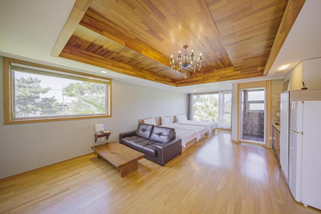 a living room with a couch and a table at Harmony Resort in Jeju