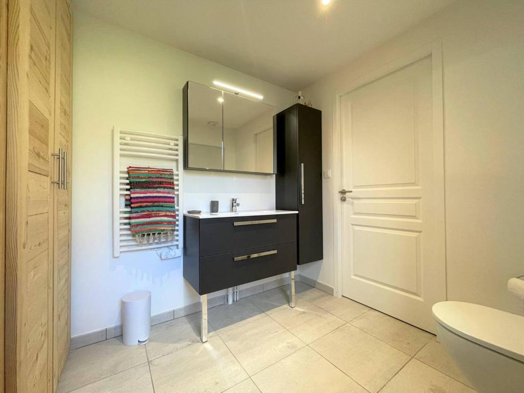 a bathroom with a sink and a black cabinet at Chalet Puy-Saint-Pierre, 4 pièces, 8 personnes - FR-1-330C-136 in Puy-Saint-Pierre