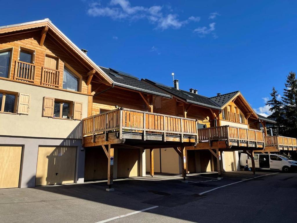 a large house with wooden balconies and a garage at Chalet Puy-Saint-Pierre, 4 pièces, 8 personnes - FR-1-330C-136 in Puy-Saint-Pierre