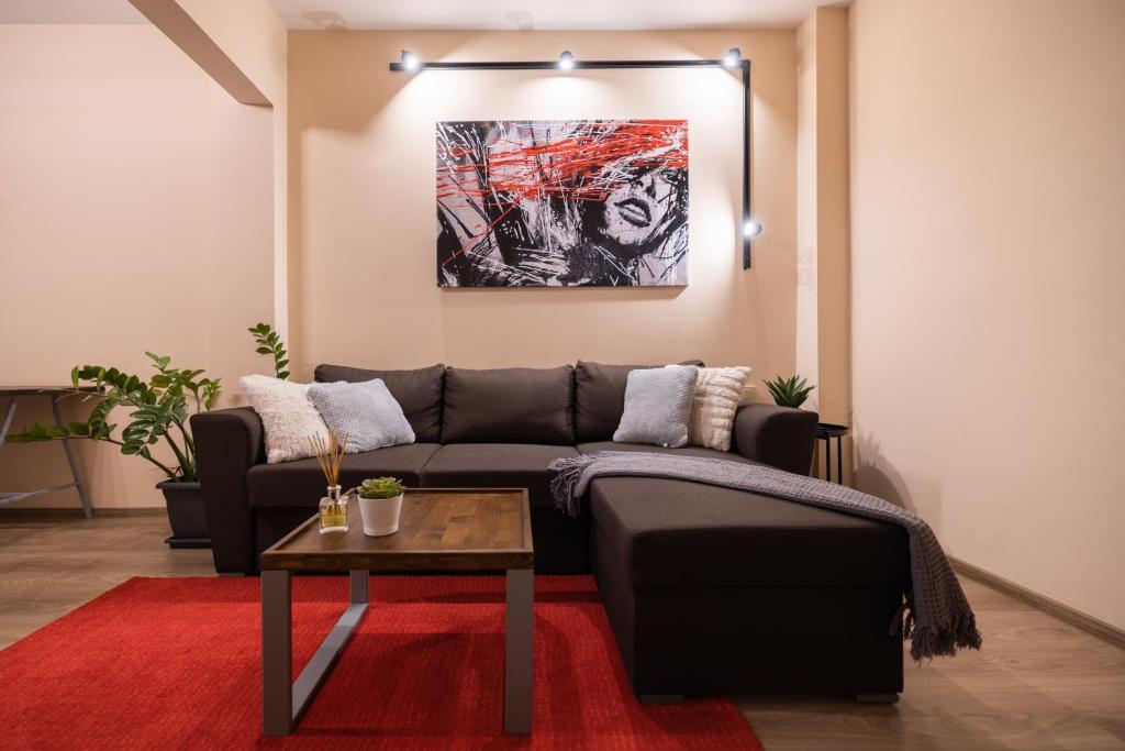 a living room with a couch and a table at The Red Point in Varna City