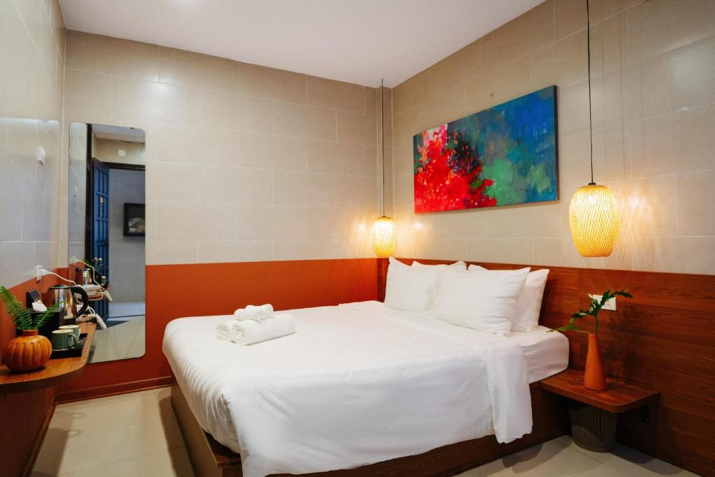 Postel nebo postele na pokoji v ubytování Hoianese Center Hotel - Truly Hoi An