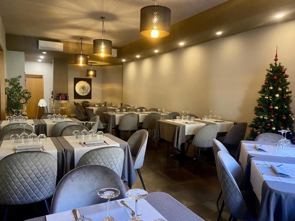 a dining room with tables and a christmas tree at Albergo Stazione in Roveredo