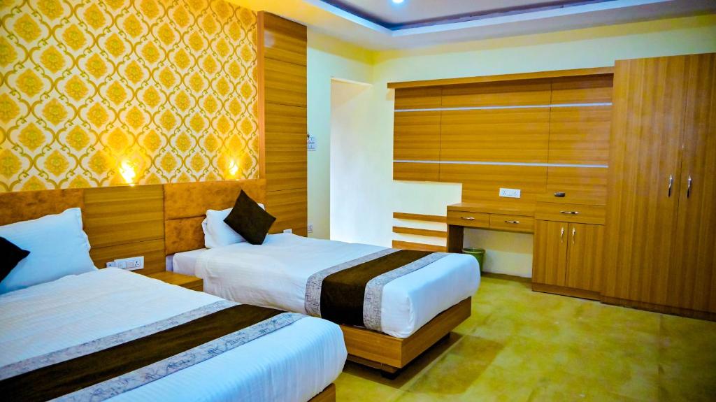 a hotel room with two beds and a cabinet at HOTEL STAR HOLIDAY PVT LTD in Bhairāhawā