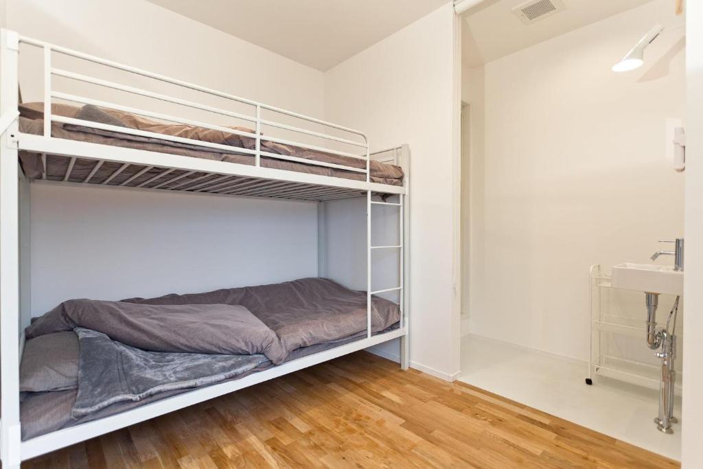 Postel nebo postele na pokoji v ubytování CASA Kamakura Espresso&BED