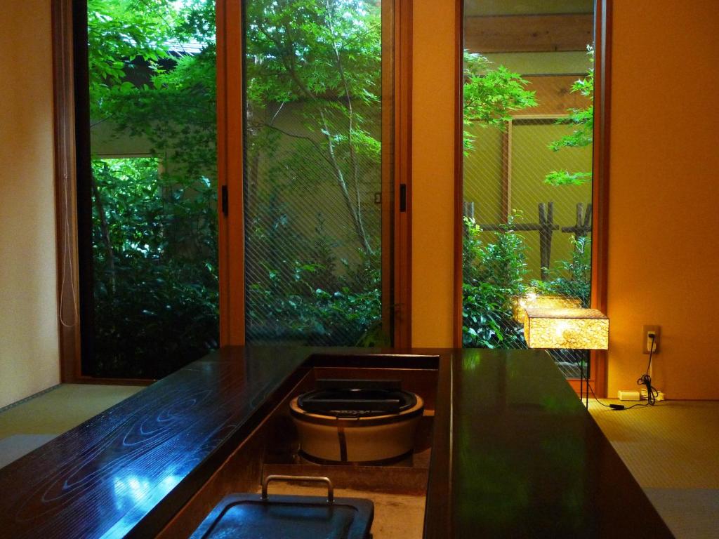 a kitchen with a counter with a large window at Suihoen in Gero