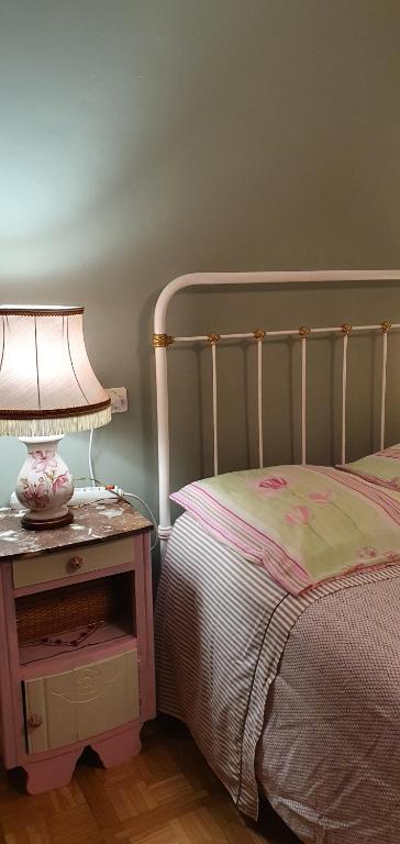 a bedroom with a bed and a table with a lamp at Horizon Aubrac Laguiole in Laguiole