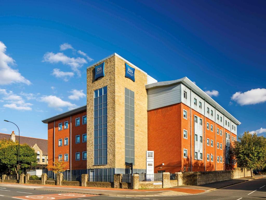a tall brick building with windows on a street at ibis budget Sheffield Arena in Sheffield