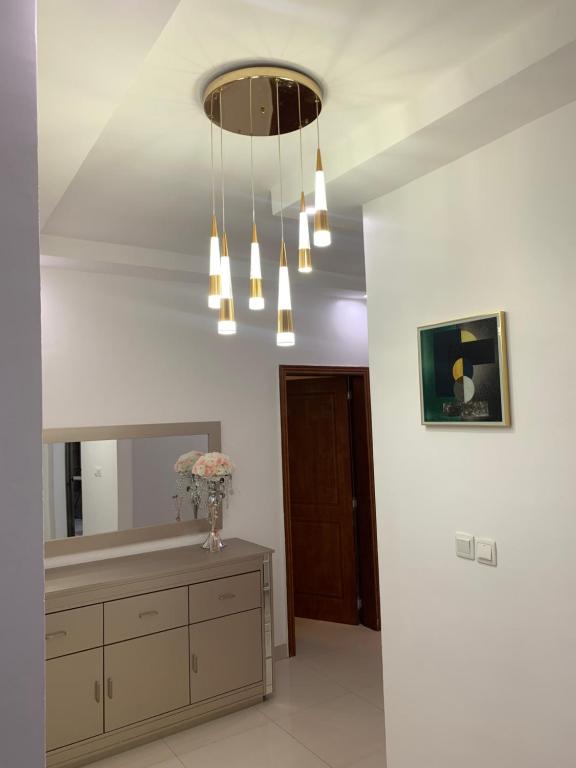 a bathroom with a vanity and a chandelier at Résidence Moussirou 2 in Dakar