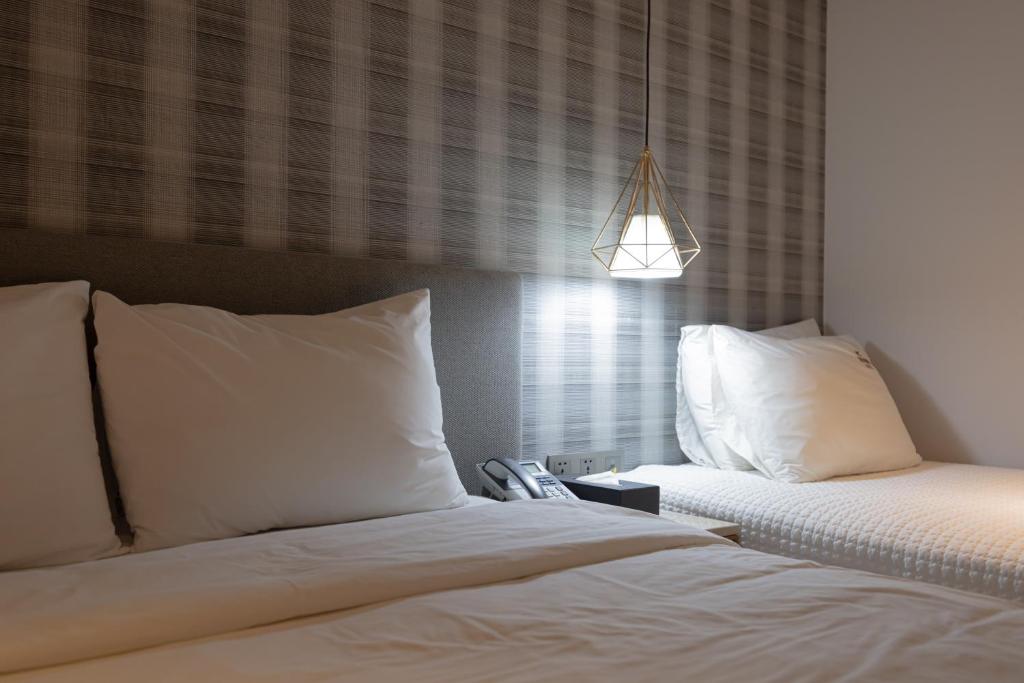 Postel nebo postele na pokoji v ubytování Hound Hotel Seomyeon-Beomcheon