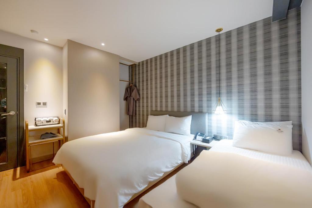 Postel nebo postele na pokoji v ubytování Hound Hotel Seomyeon-Beomcheon
