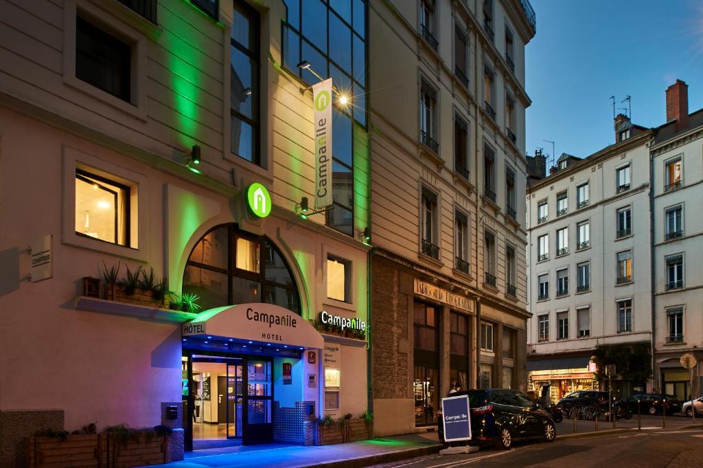 a building with a green sign on the side of it at Campanile Lyon Centre - Berges du Rhône in Lyon