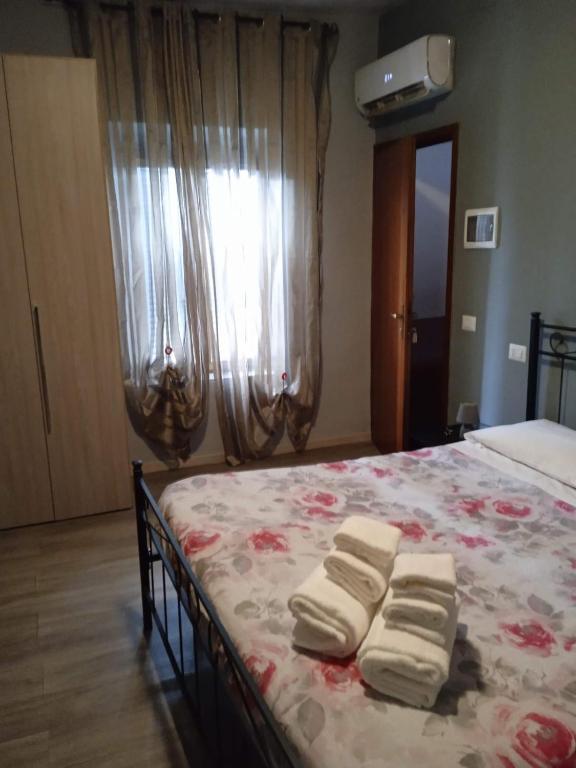 een slaapkamer met een bed met drie vouwhanddoeken erop bij Bed-Bred SELF CHECK-IN in Parma