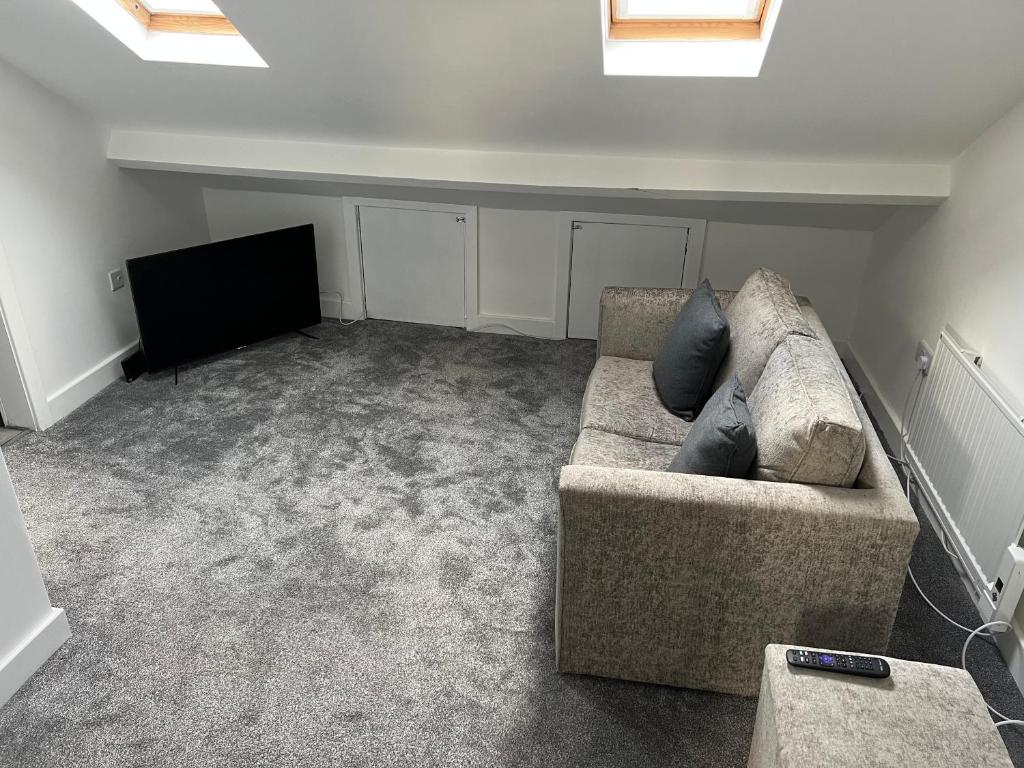 a living room with a couch and a flat screen tv at Liley Apartments in Stockton-on-Tees