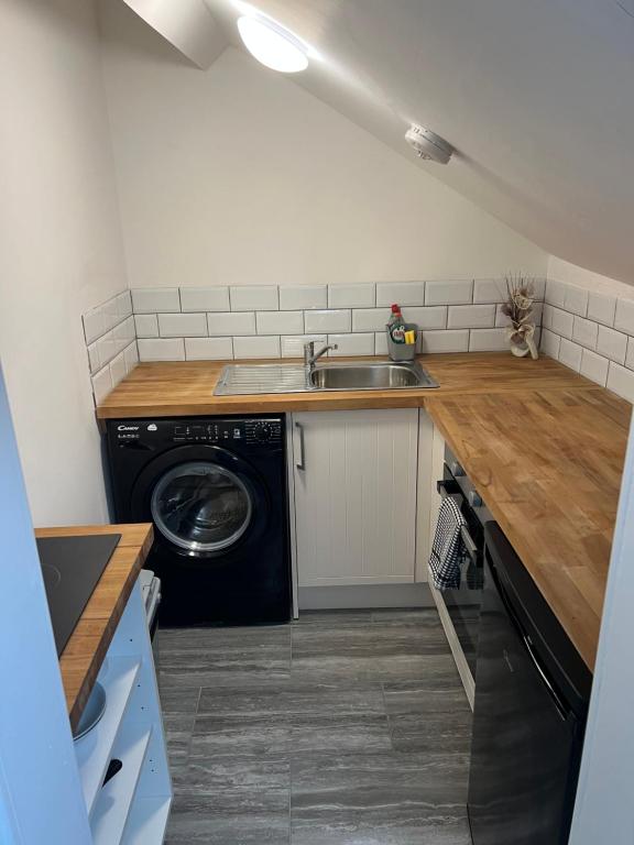 a kitchen with a sink and a washing machine at Liley Apartments in Stockton-on-Tees