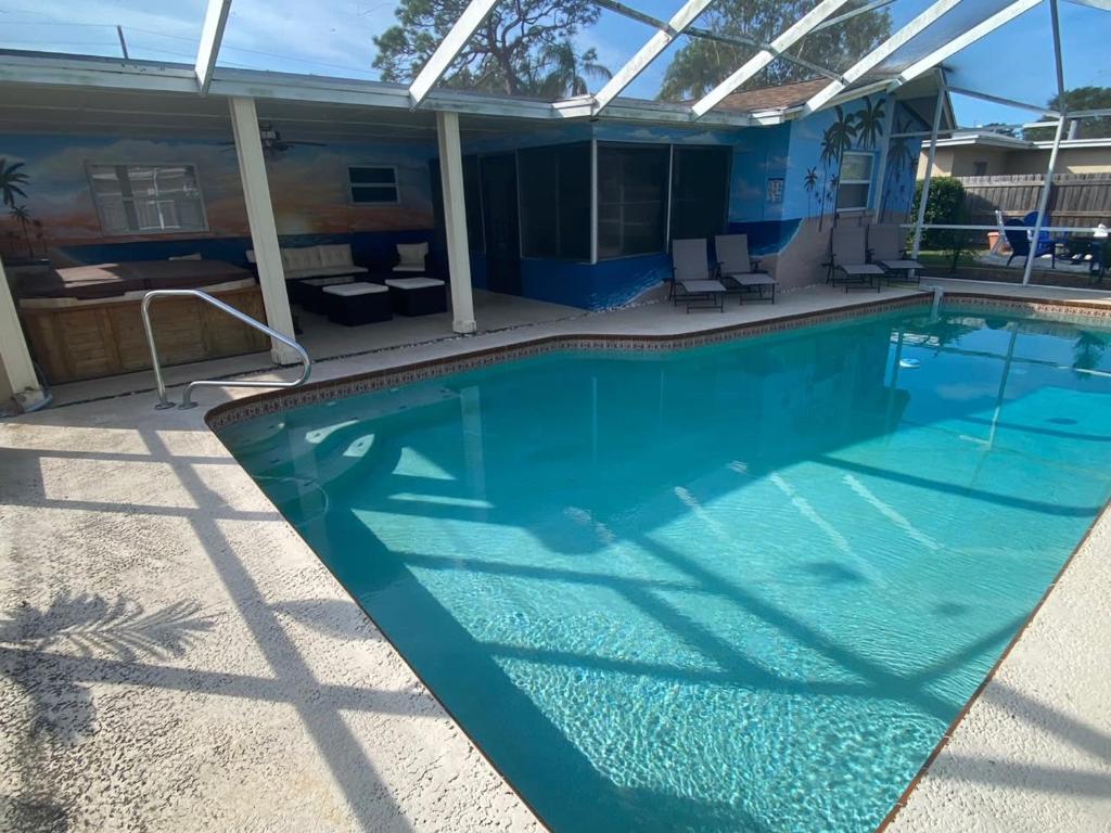 a large swimming pool with blue water at Close to beaches Pet friendly heated pool hot tub in Largo