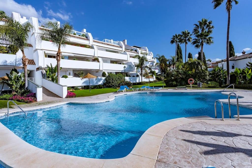 a large swimming pool in front of a building at Molo Bahia Apartment Near the beach in Marbella