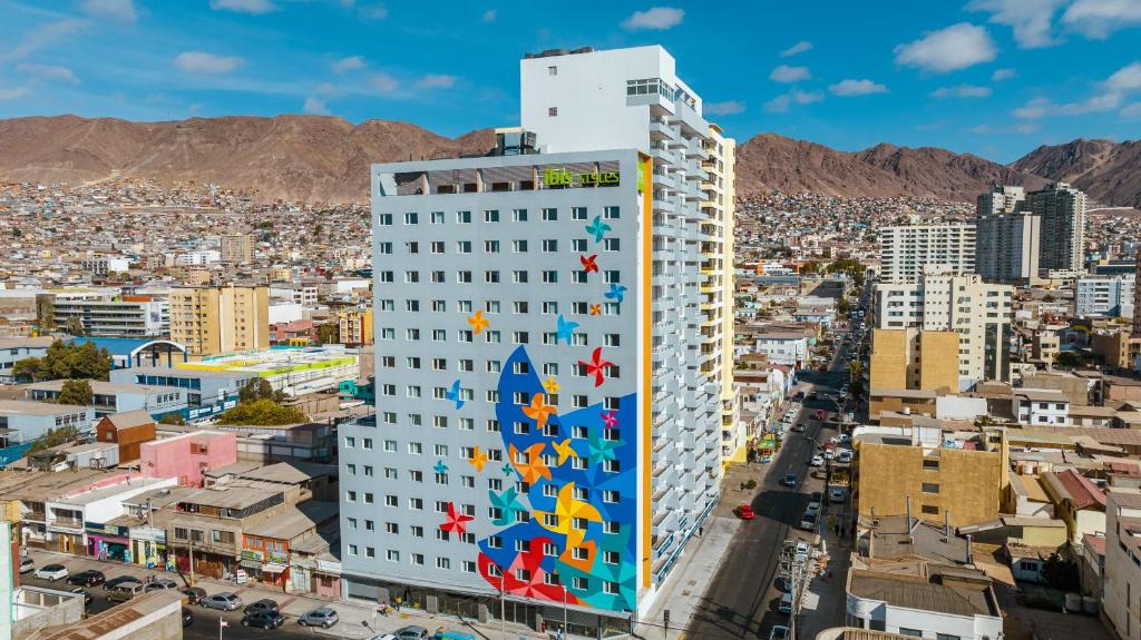a tall building with a mural on the side of it at ibis Styles Antofagasta in Antofagasta
