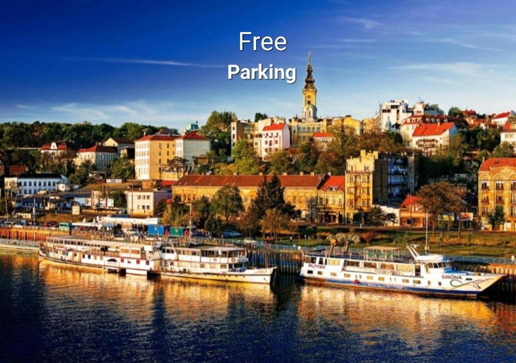 a group of boats docked in a river with a city at Apartment Petra 071 in Belgrade