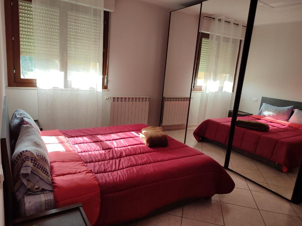 a bedroom with two beds and a mirror at Appartamento di Durante Achille trilocale di 80 mq in Arezzo