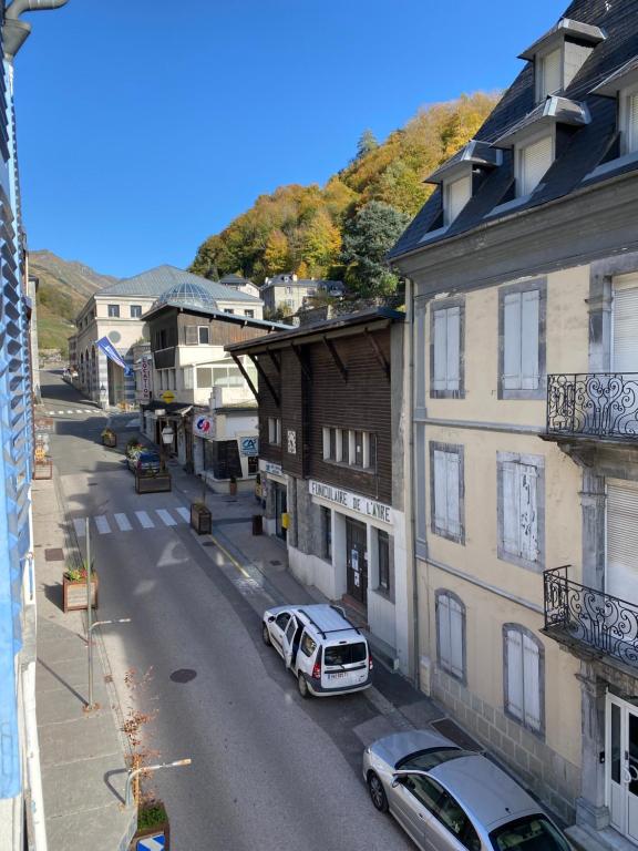 a city street with cars parked on the side of a building at Boost Your Immo Ramond Barèges PM26 in Barèges