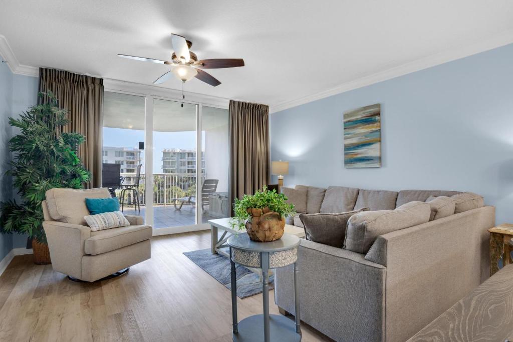 a living room with a couch and a chair at Heron 507- A Wave From It All in Fort Walton Beach