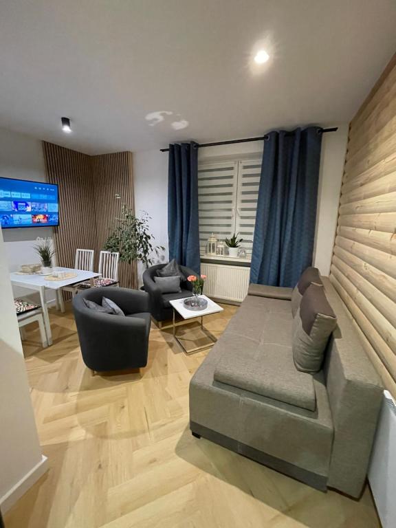 a living room with a couch and chairs and a table at EXPO KRUPÓWKI 60 APARTMENT in Zakopane