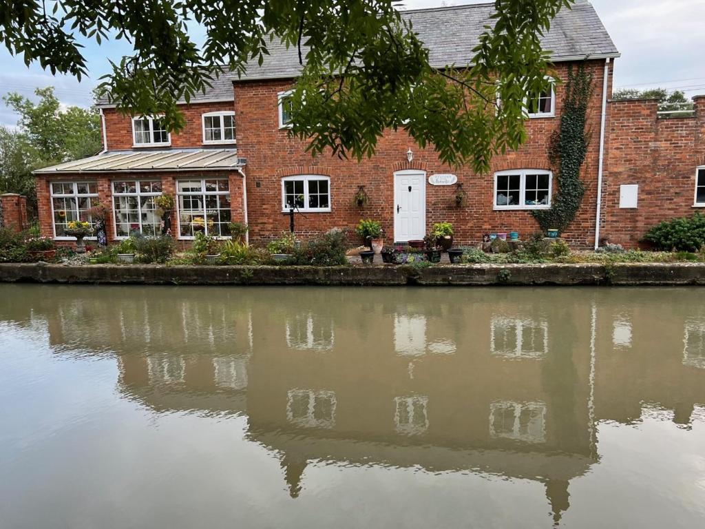 a brick building next to a body of water at Canalside B and B 