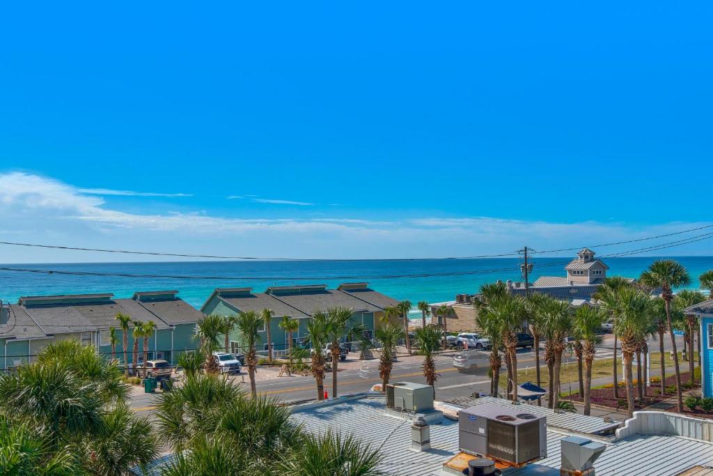 an aerial view of a resort with palm trees and the ocean at Leeward Key 401 in Destin
