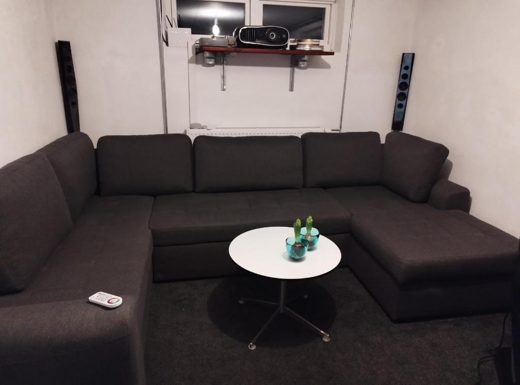 a living room with a couch and a table at Louisiana Rent in Espergærde