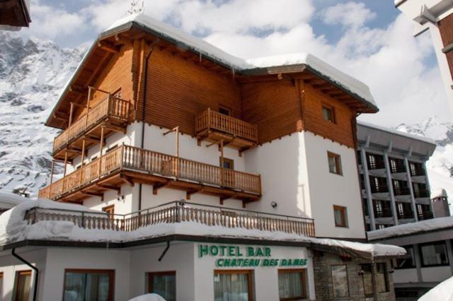 a hotel inn with a balcony in the snow at Hotel Chateau des Dames in Breuil-Cervinia