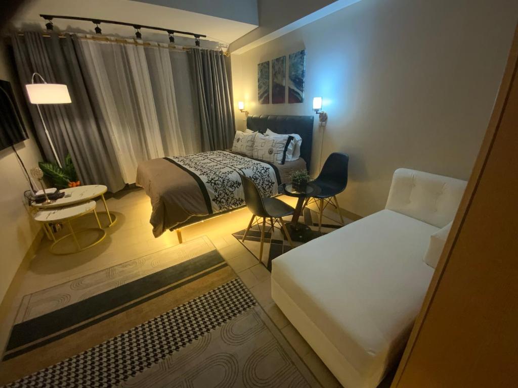 a small bedroom with a bed and a couch at The Haven at One Eastwood Tower 1 in Manila