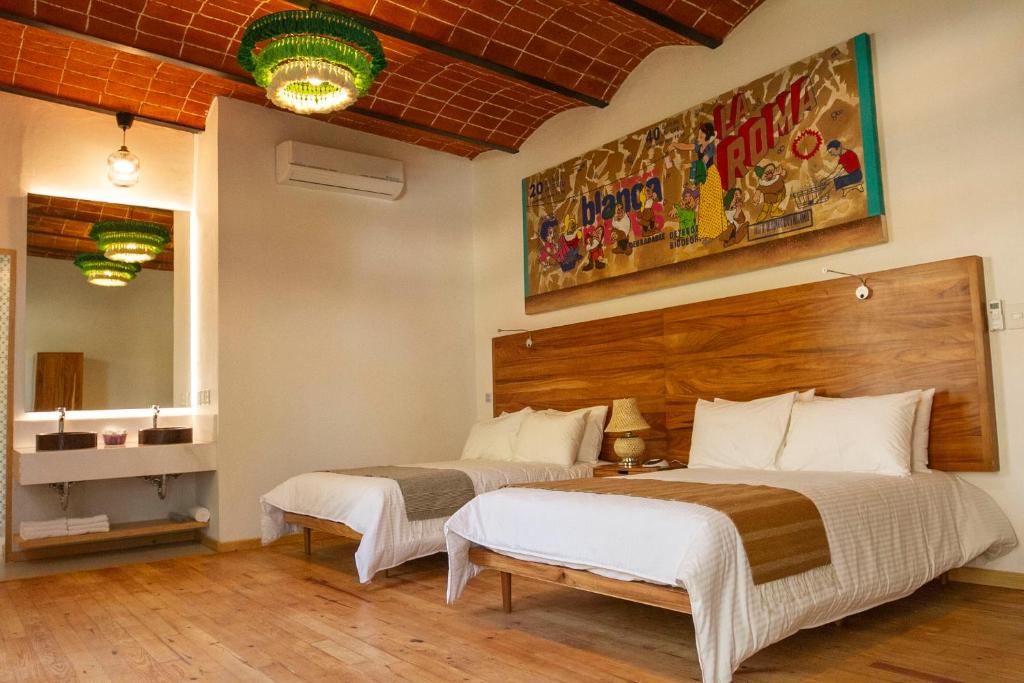 a bedroom with two beds and a mirror at NaNa Vida CDMX in Mexico City