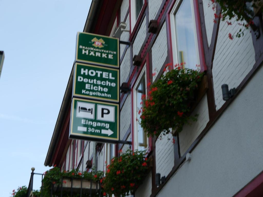 a group of signs on the side of a building at Hotel Deutsche Eiche Northeim in Northeim