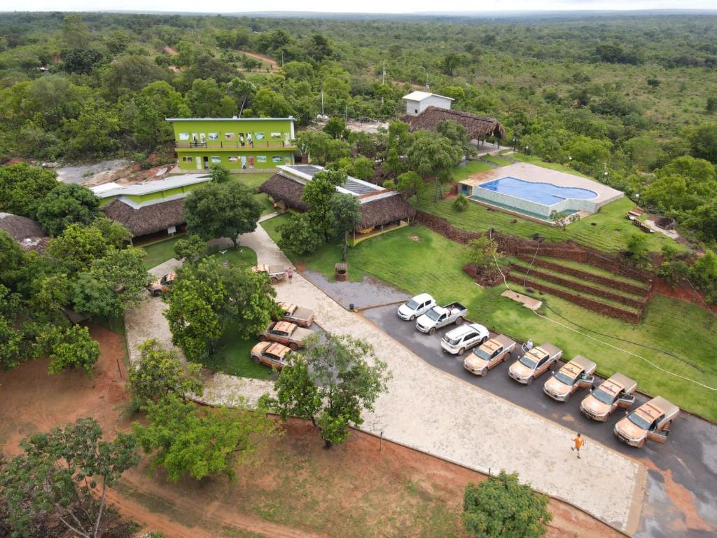 an overhead view of a parking lot with cars and a pool at Pousada Cristal Dourado in Mateiros