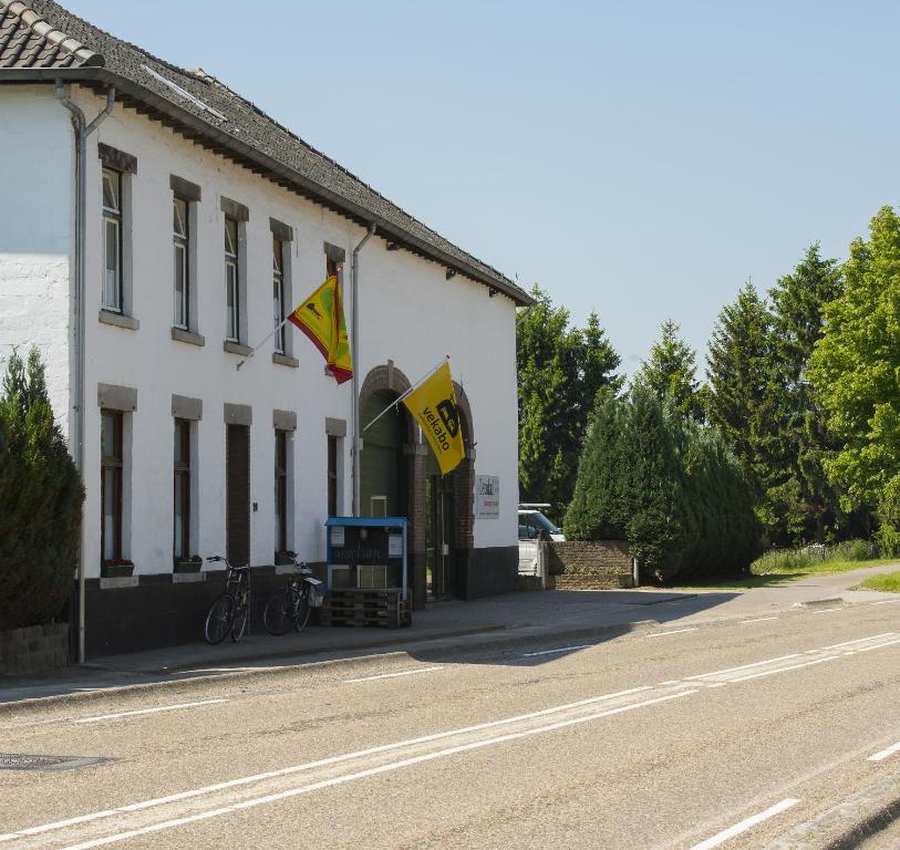 a building with flags on the side of a street at Vakantie oord Zonnehoeve in Valkenburg