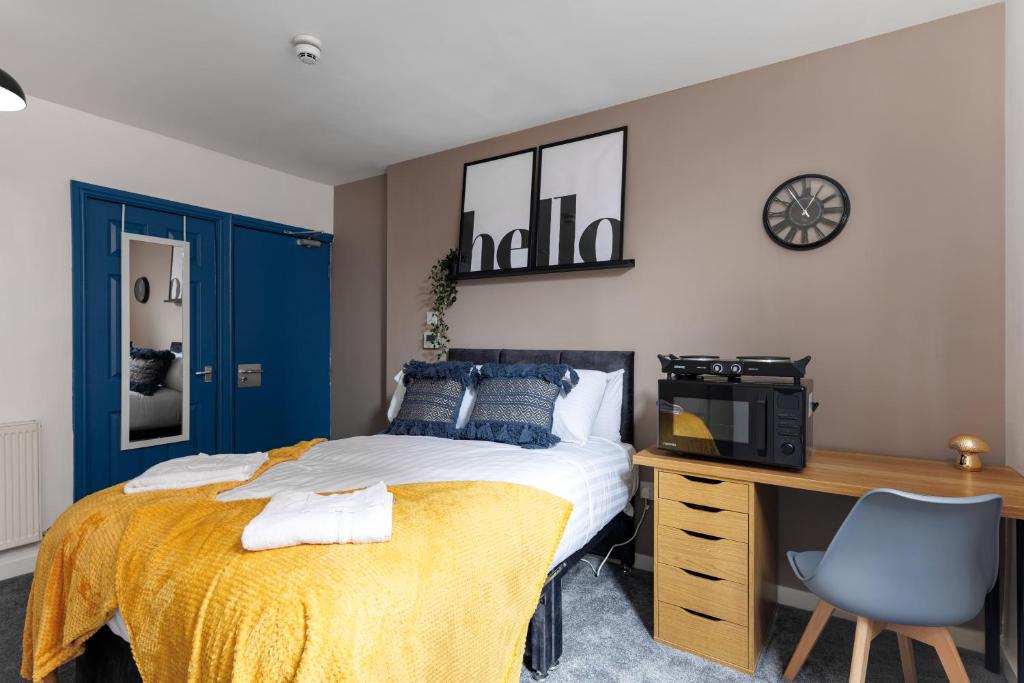 a bedroom with a bed and a desk with a computer at City Centre Studio 5 with Kitchenette, Free Wifi and Smart TV with Netflix by Yoko Property in Middlesbrough