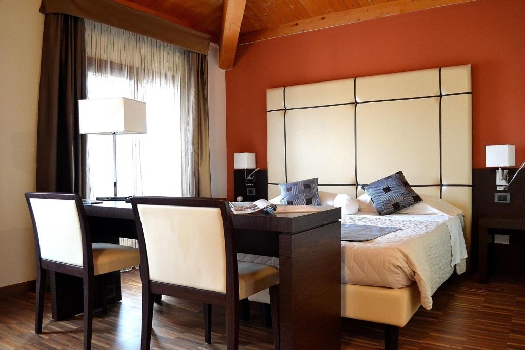 Postel nebo postele na pokoji v ubytování Albergo Minuetto