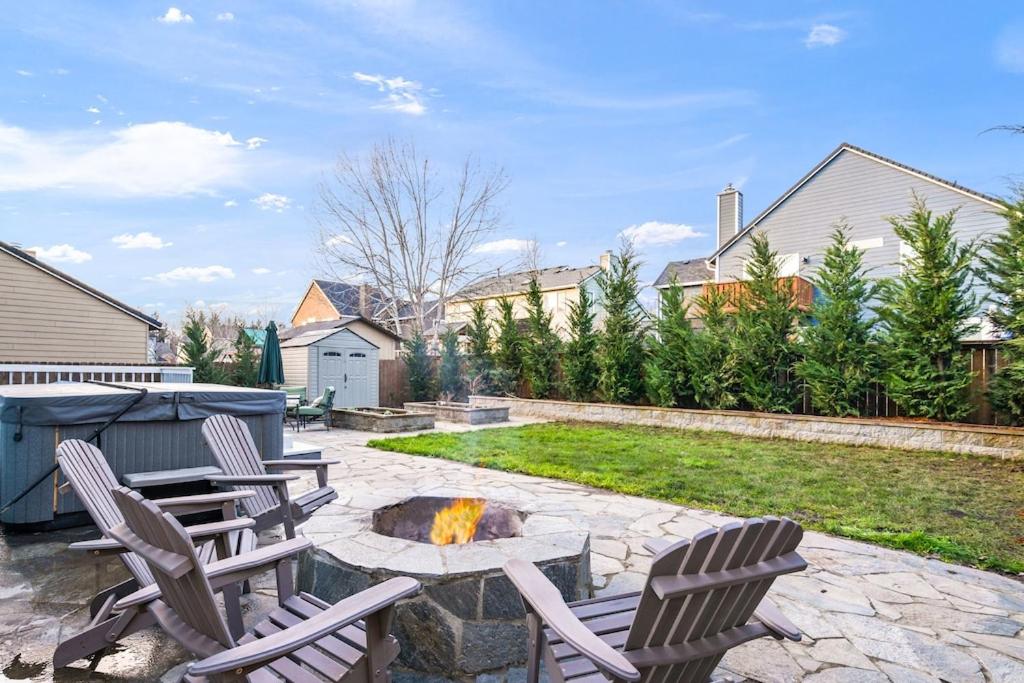 a backyard with two chairs and a fire pit at The Place To Be; With A Hot Tub! in Clackamas