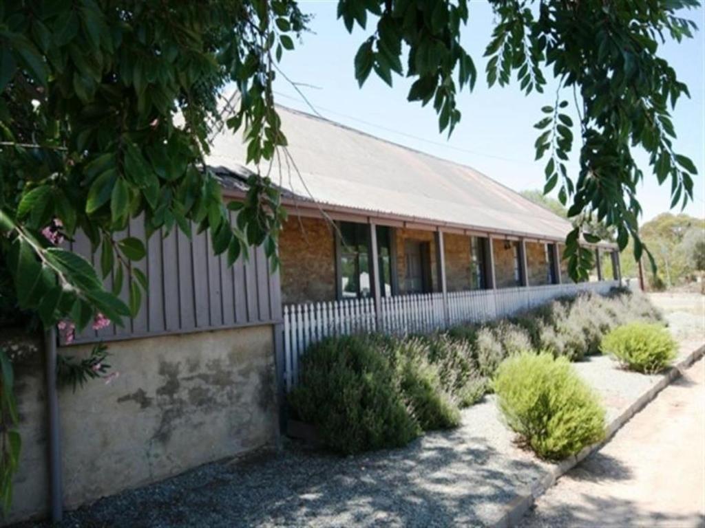 a brick building with bushes in front of it at Bakehouse Burra in Burra