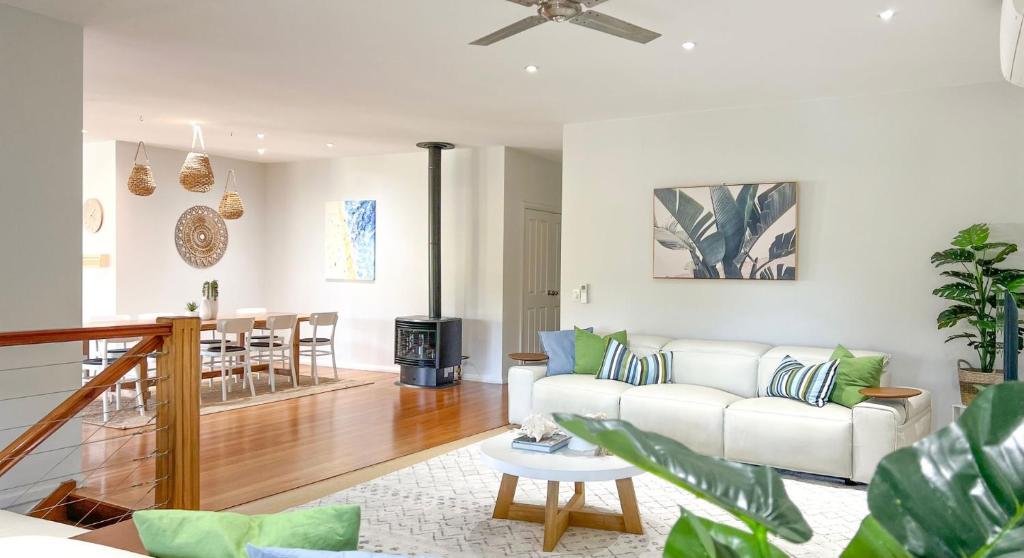 a living room with a white couch and a table at Sea Breeze in Elizabeth Beach