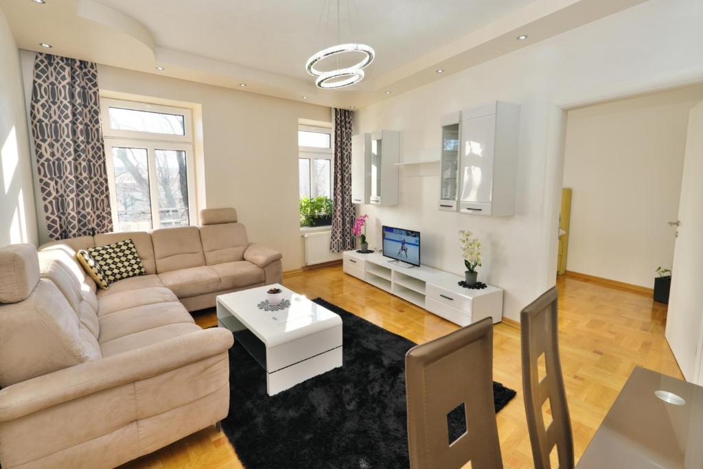 a living room with a couch and a table at Lux Apartments Prestige in Vienna