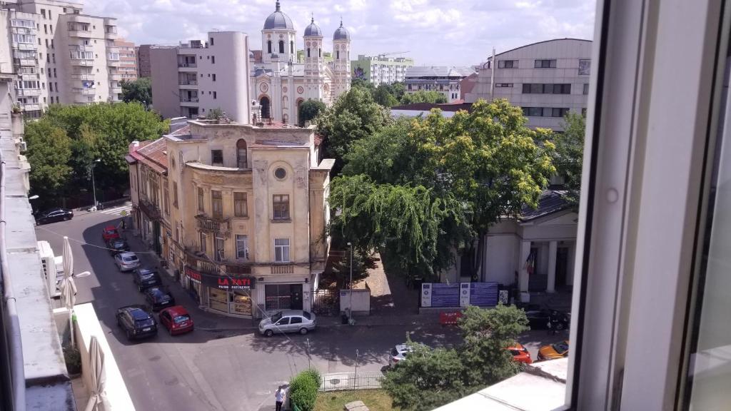 a view from a window of a city street with a building at Private room at Ceausescu's place in Old City Unirii Square in Bucharest