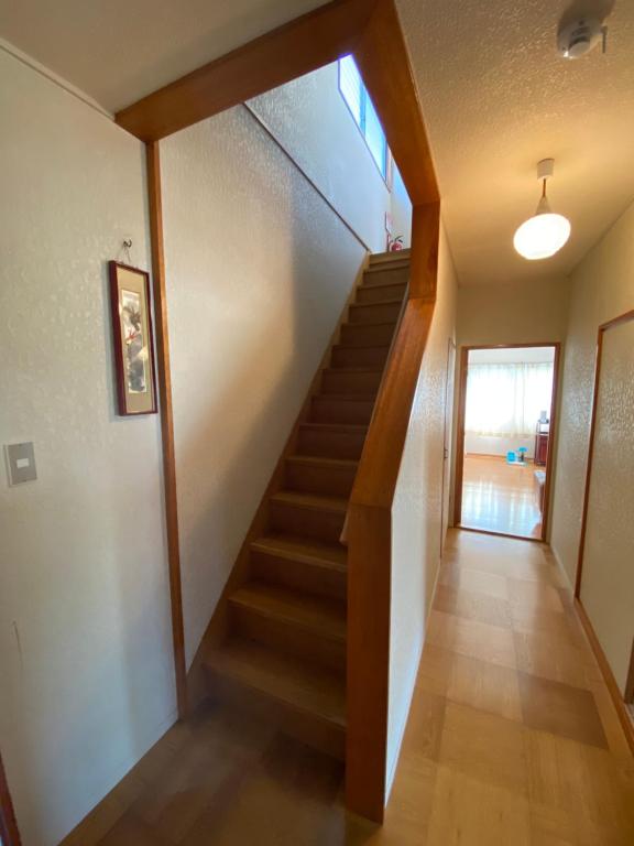 a hallway with a staircase in a house at AMITIE VILLA（友安居）民宿 in Tannowa