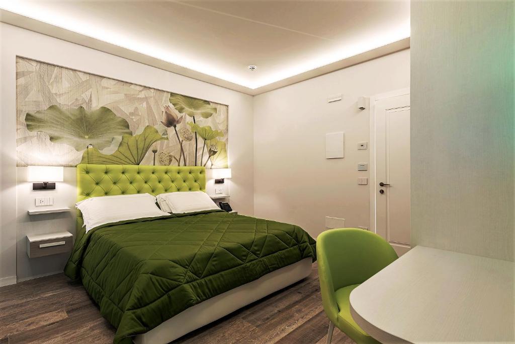Postel nebo postele na pokoji v ubytování Petit Hotel