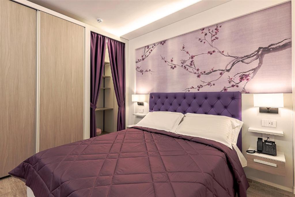 Postel nebo postele na pokoji v ubytování Petit Hotel